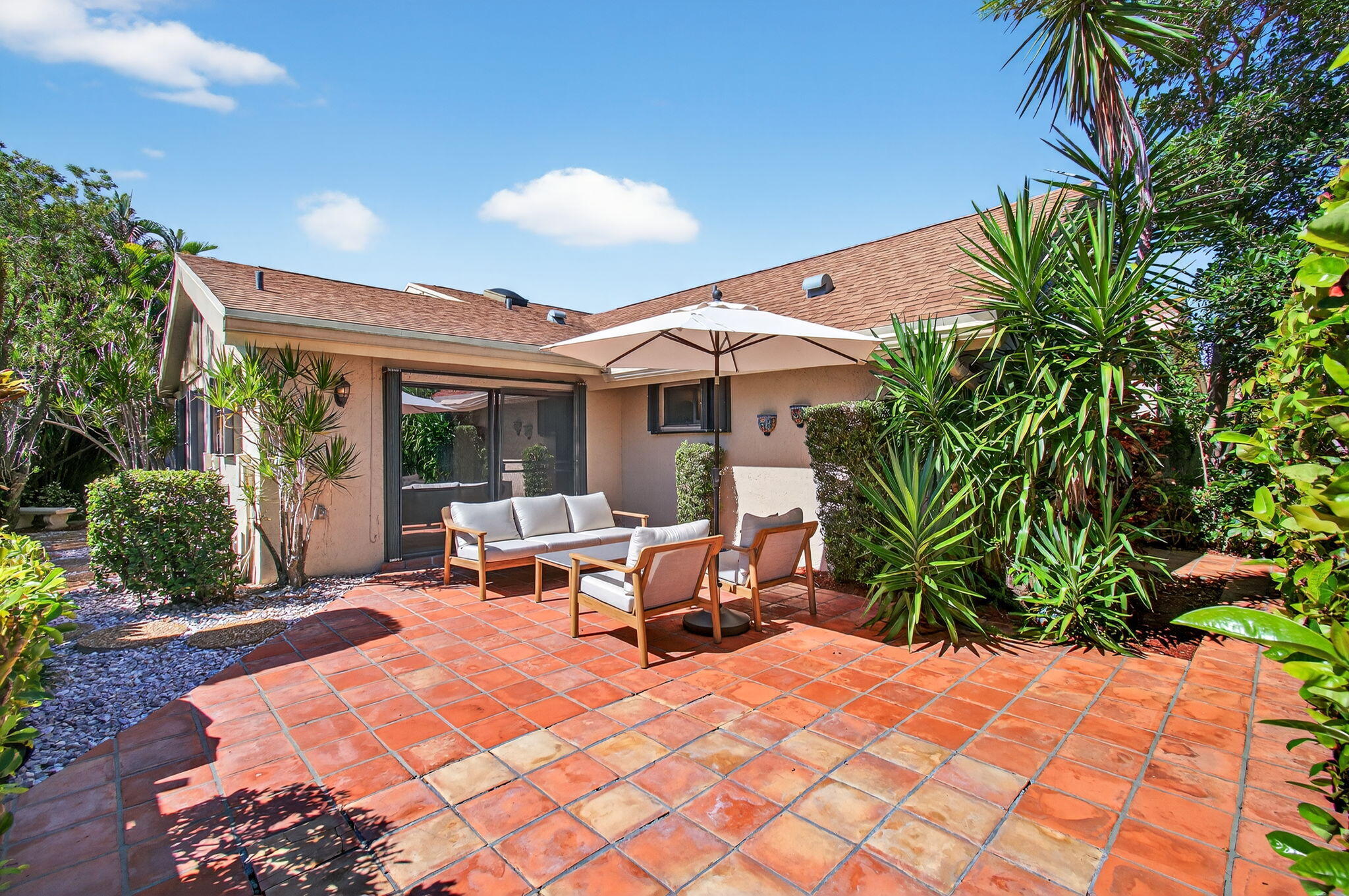 7745 Stanway Place Boca Raton, FL 33433 - Photo 60 of 90 a view of a patio with table and chairs potted plants and palm tree