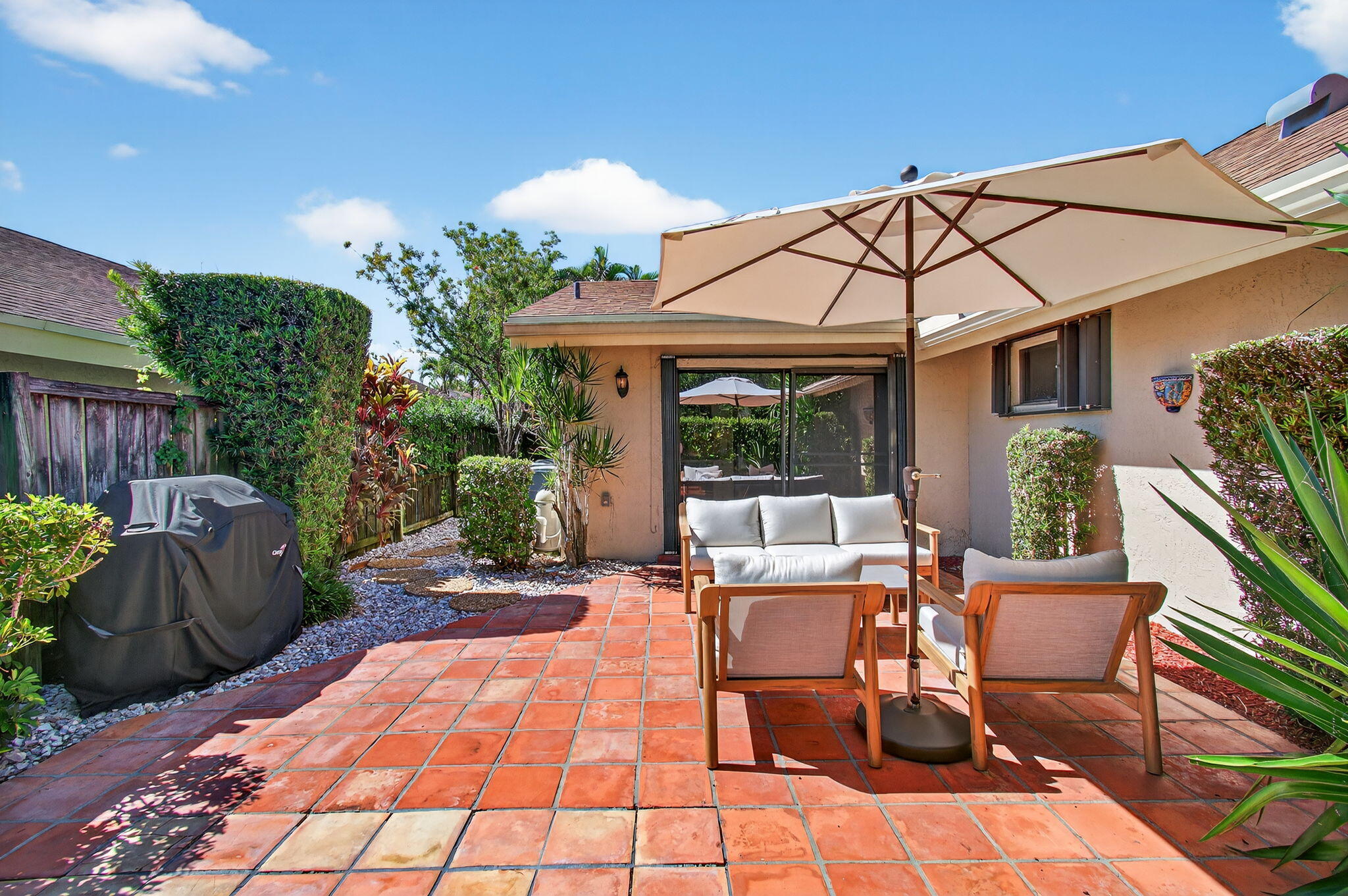 7745 Stanway Place Boca Raton, FL 33433 - Photo 64 of 90 a view of a patio with a table and chairs under an umbrella