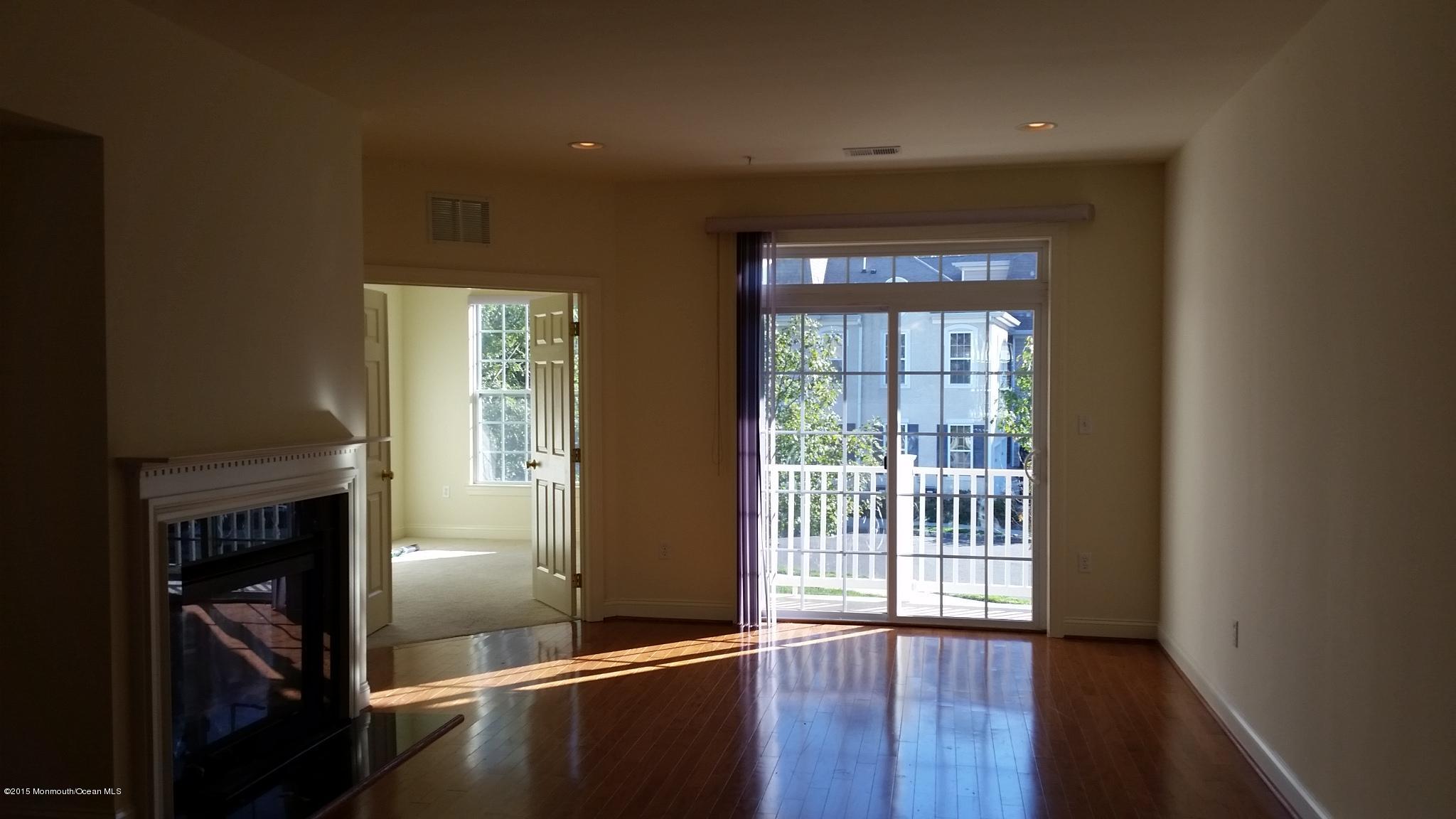 902 Abby Road Middletown, NJ 07748 - Photo 13 of 61 a view of a hallway with wooden floor and a fireplace