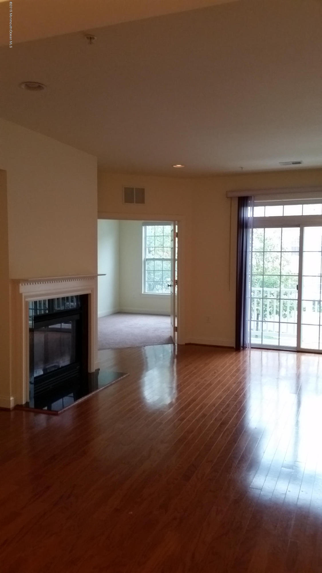 902 Abby Road Middletown, NJ 07748 - Photo 17 of 61 an empty room with windows and fireplace