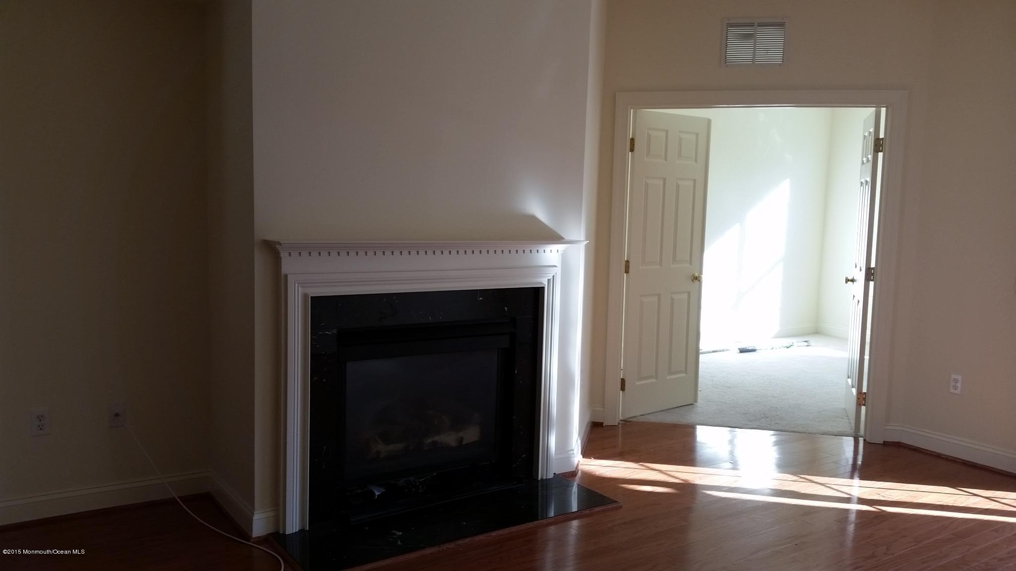 902 Abby Road Middletown, NJ 07748 - Photo 19 of 61 a view of a livingroom with wooden floor and a fireplace