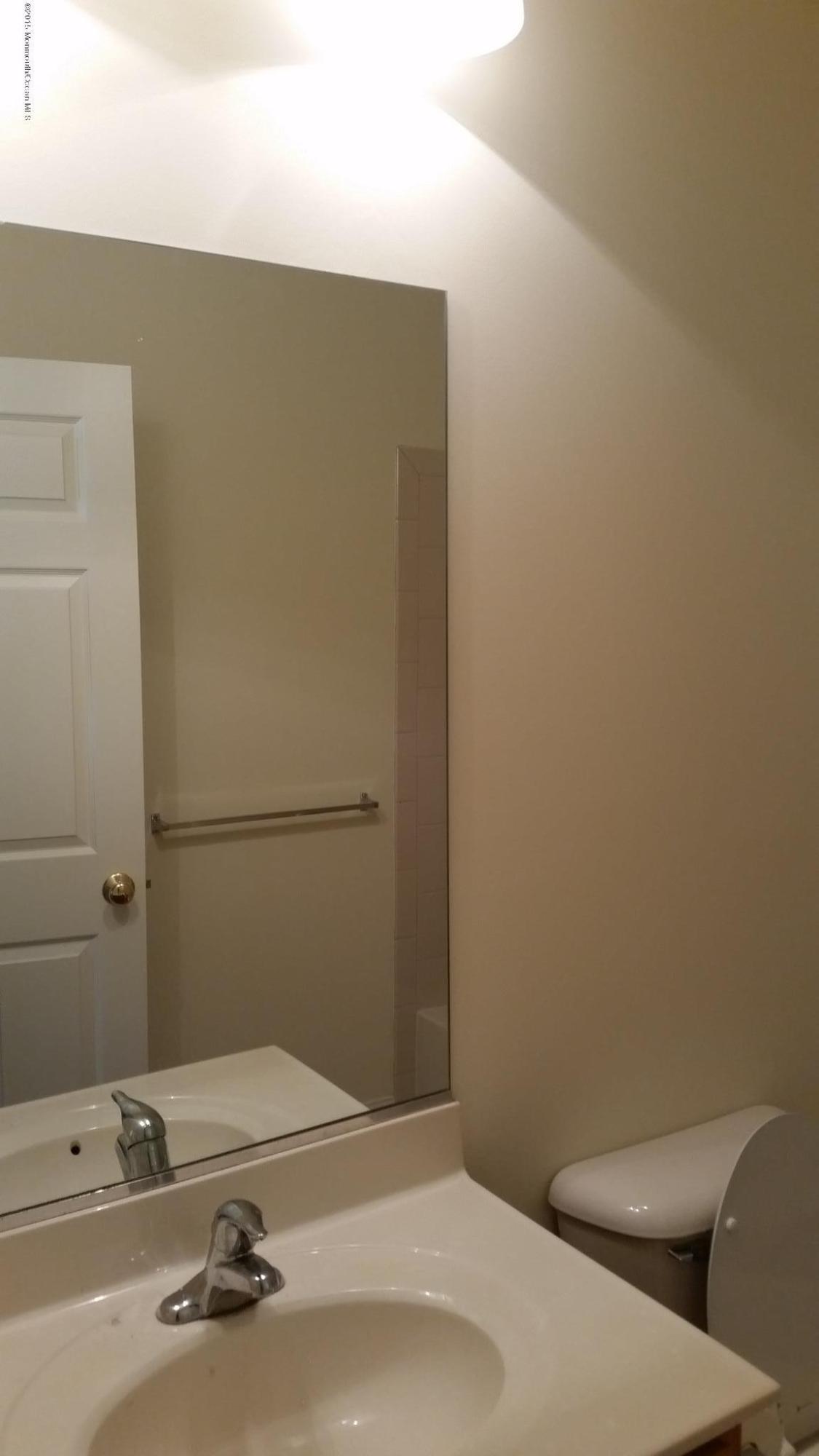 902 Abby Road Middletown, NJ 07748 - Photo 24 of 61 a bathroom with a sink and a toilet