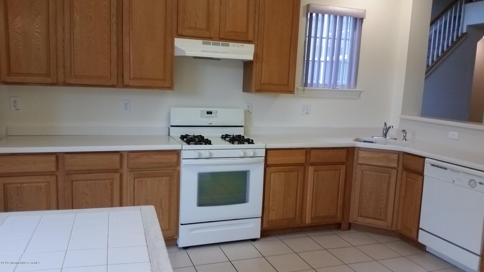 902 Abby Road Middletown, NJ 07748 - Photo 37 of 61 a kitchen with granite countertop a sink a stove and cabinets