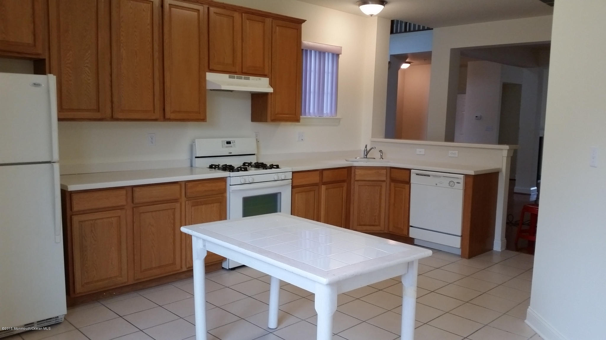 902 Abby Road Middletown, NJ 07748 - Photo 38 of 61 a kitchen with stainless steel appliances a stove a sink cabinets and a refrigerator