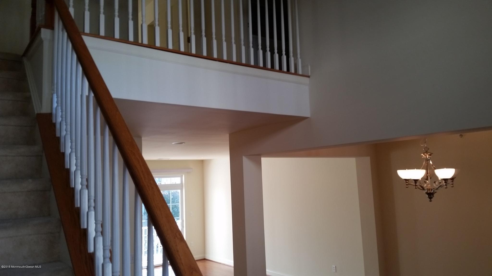 902 Abby Road Middletown, NJ 07748 - Photo 41 of 61 a view of staircase with wooden floor and metal railing