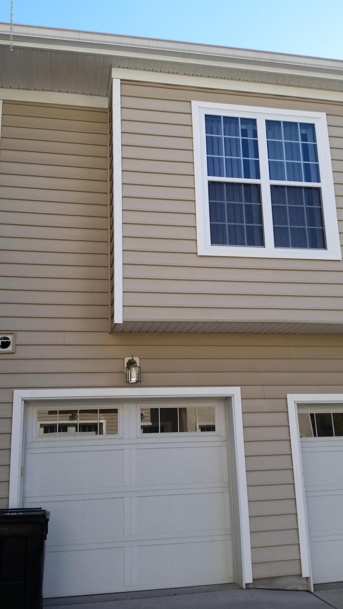 902 Abby Road Middletown, NJ 07748 - Photo 5 of 61 a front view of a house with large windows