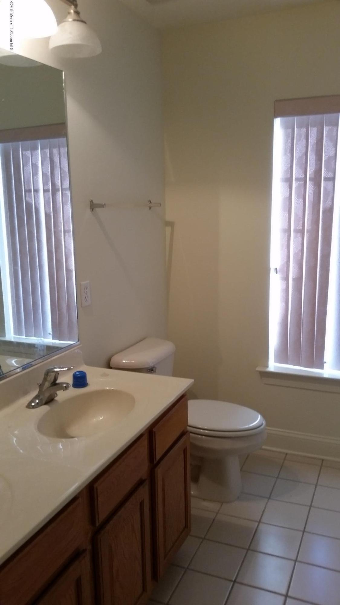 902 Abby Road Middletown, NJ 07748 - Photo 58 of 61 a bathroom with a sink a toilet and tub