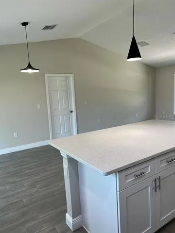 a view of a refrigerator in kitchen and wooden floor
