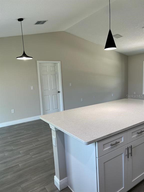 1042 Hickory Lane Cocoa, FL 32922 - Photo 4 of 8 a view of a refrigerator in kitchen and wooden floor