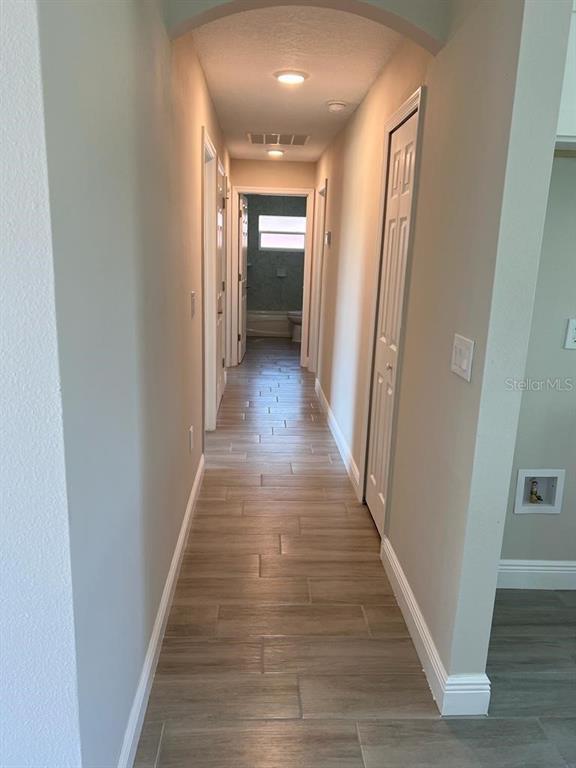 1042 Hickory Lane Cocoa, FL 32922 - Photo 6 of 8 a view of a hallway with wooden floor