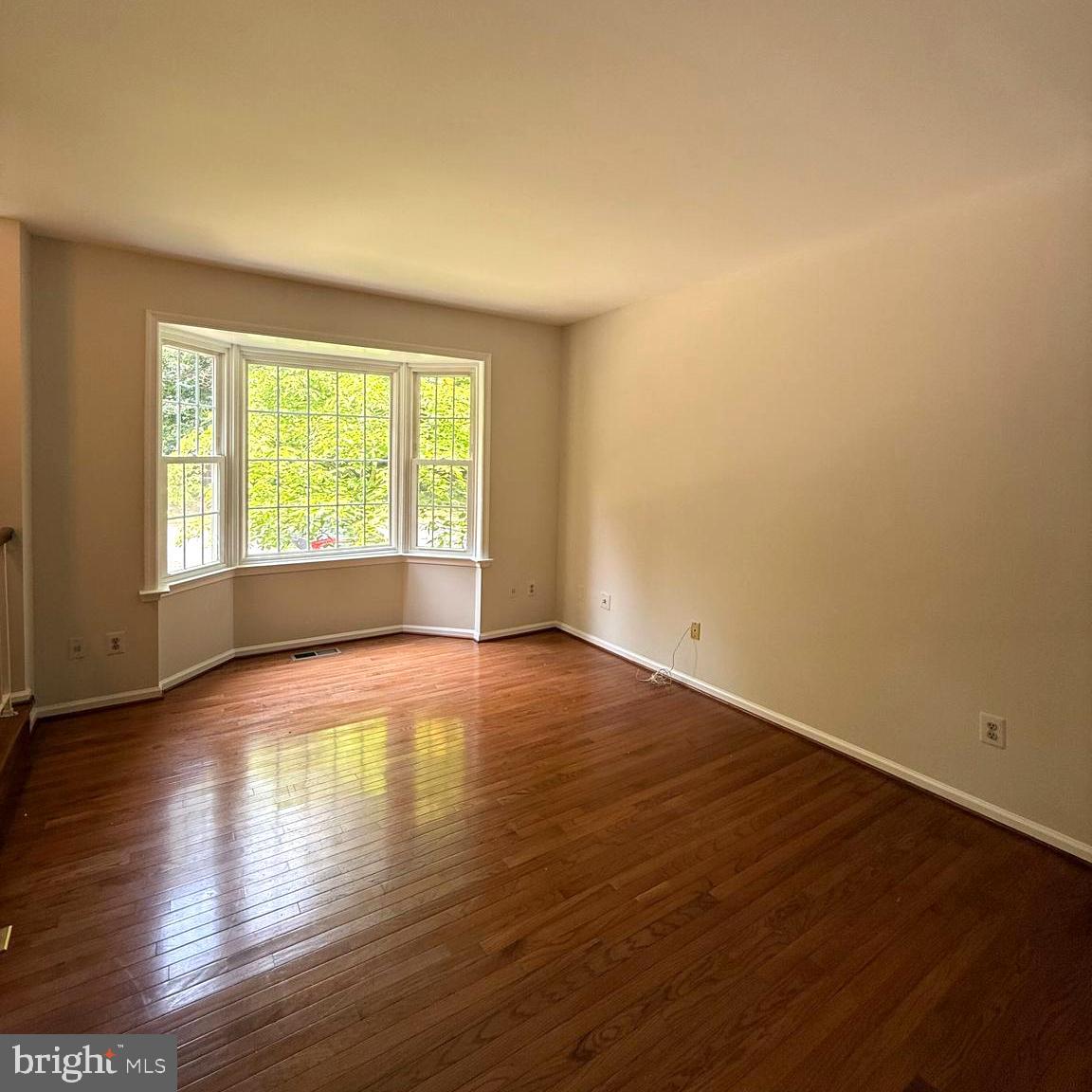 8442 Springfield Oaks Drive Springfield, VA 22153 - Photo 3 of 31 a view of empty room with wooden floor and fan