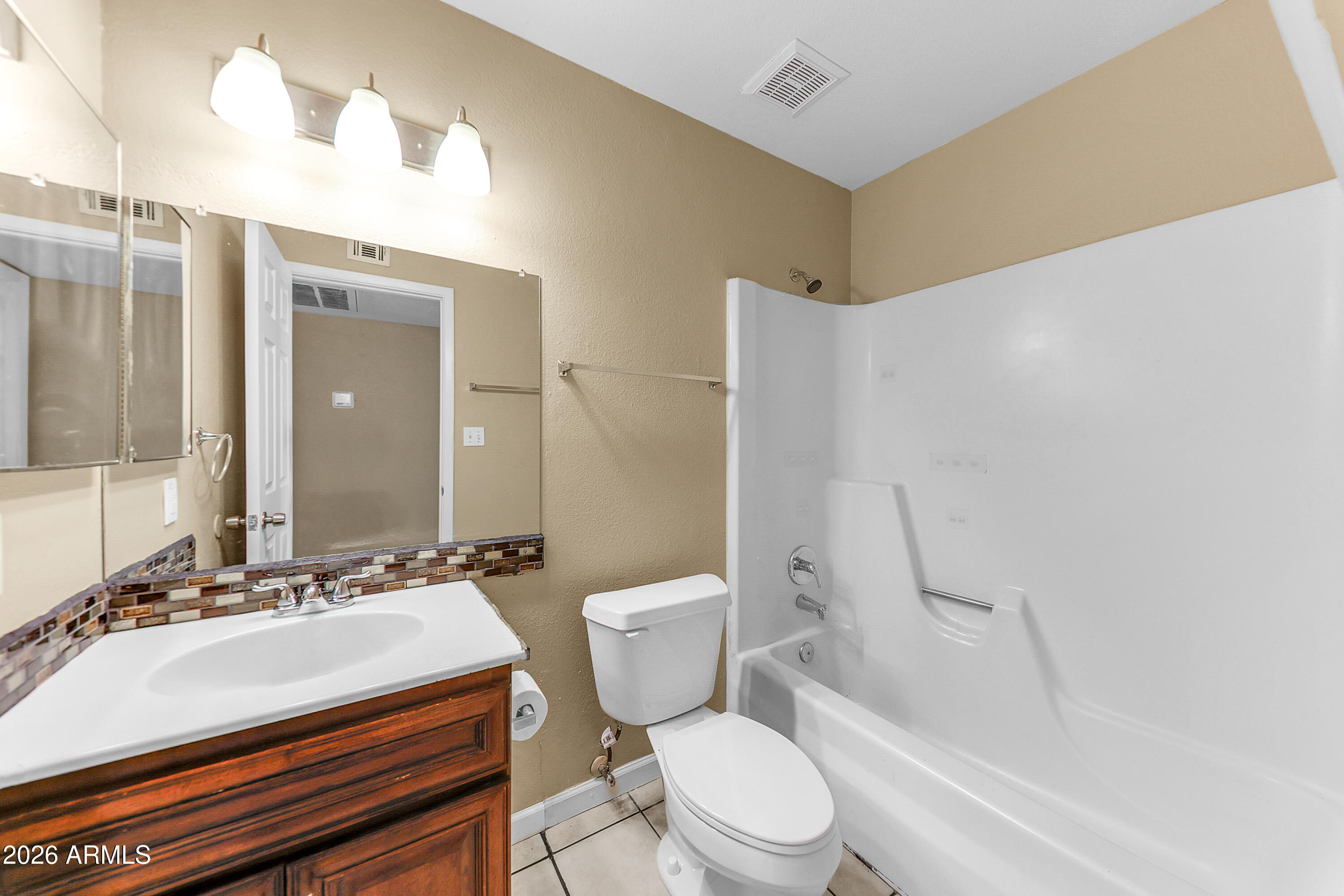 4723 East Vineyard Road Phoenix, AZ 85042 - Photo 24 of 27 a bathroom with a sink a toilet and shower