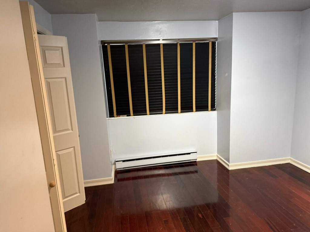 11 Hulbert Road, Unit 15 Worcester, MA 01603 - Photo 3 of 9 an empty room with wooden floor