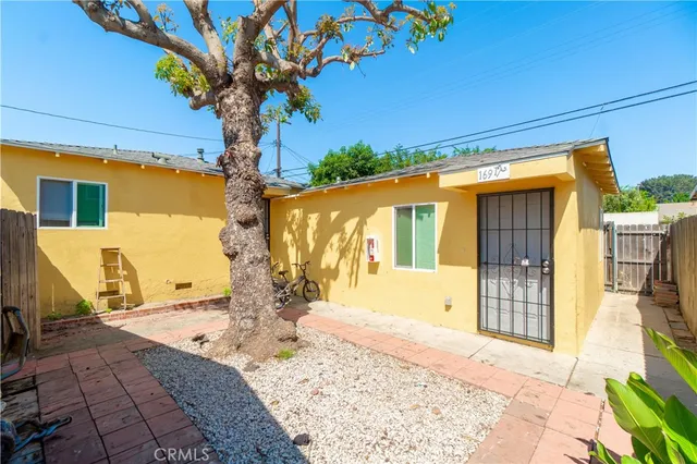a kitchen with a sink and wooden floor