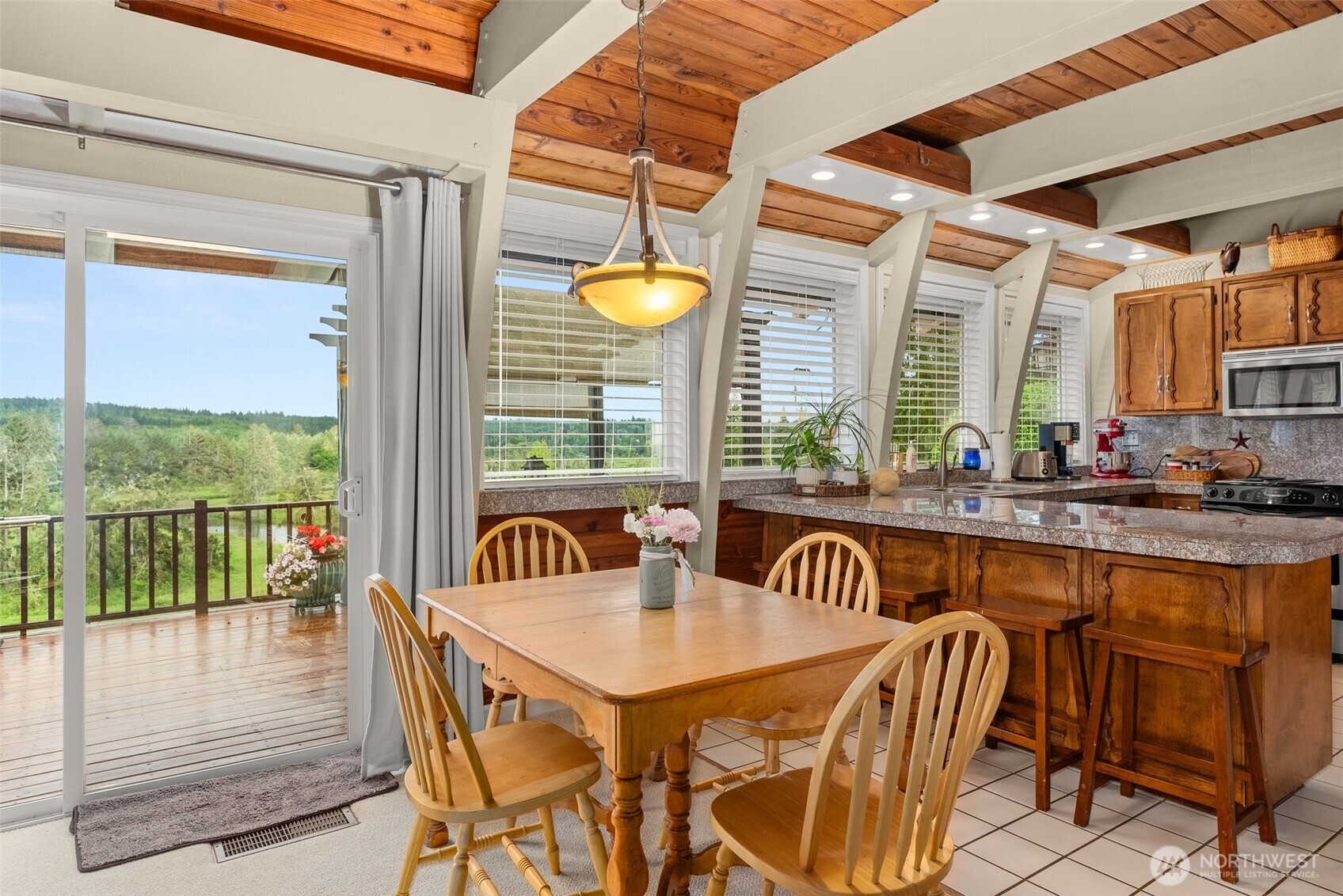 1508 Bloomhardt Road Raymond, WA 98577 - Photo 17 of 40 a view of a dining table and chairs with an outdoor view