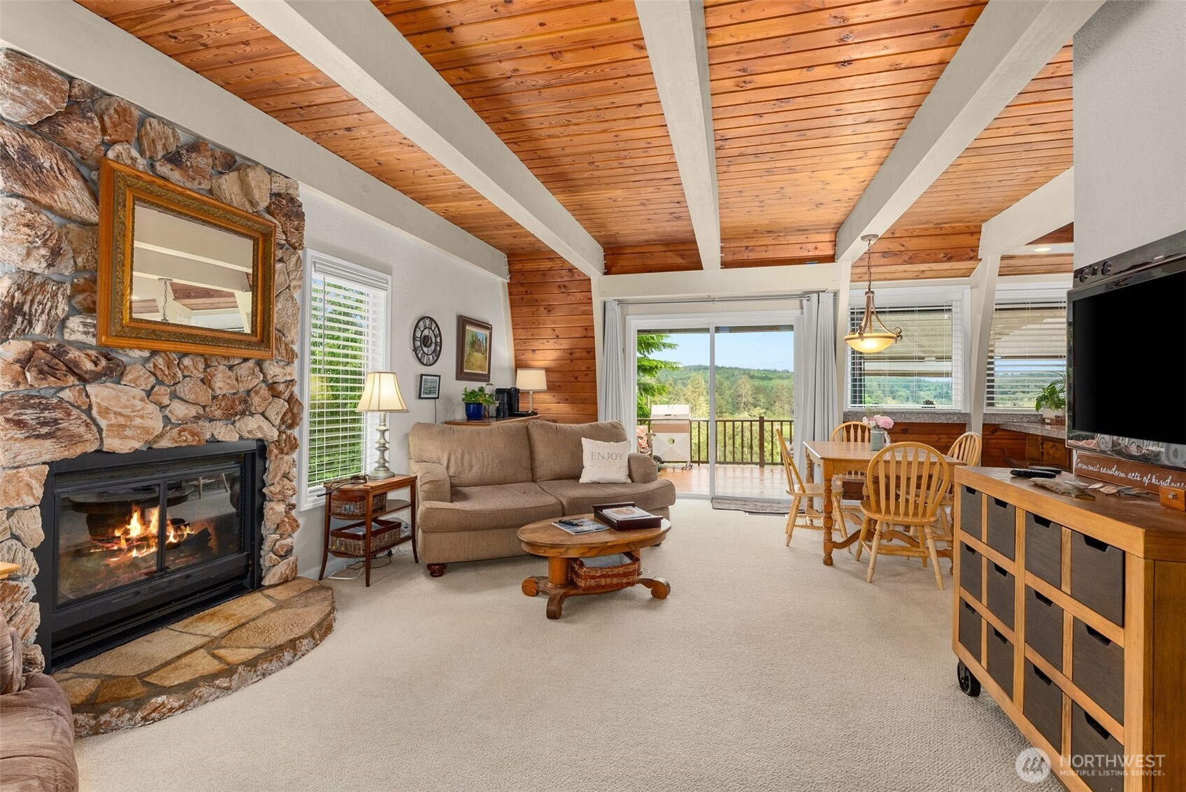 1508 Bloomhardt Road Raymond, WA 98577 - Photo 20 of 40 a living room with furniture a flat screen tv and a fireplace