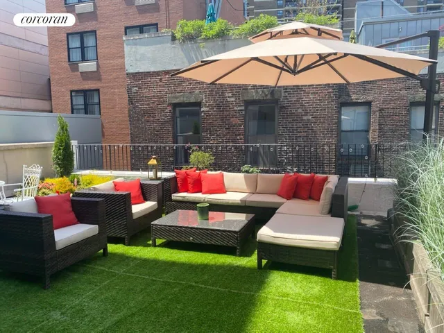 a living room with furniture and a potted plant