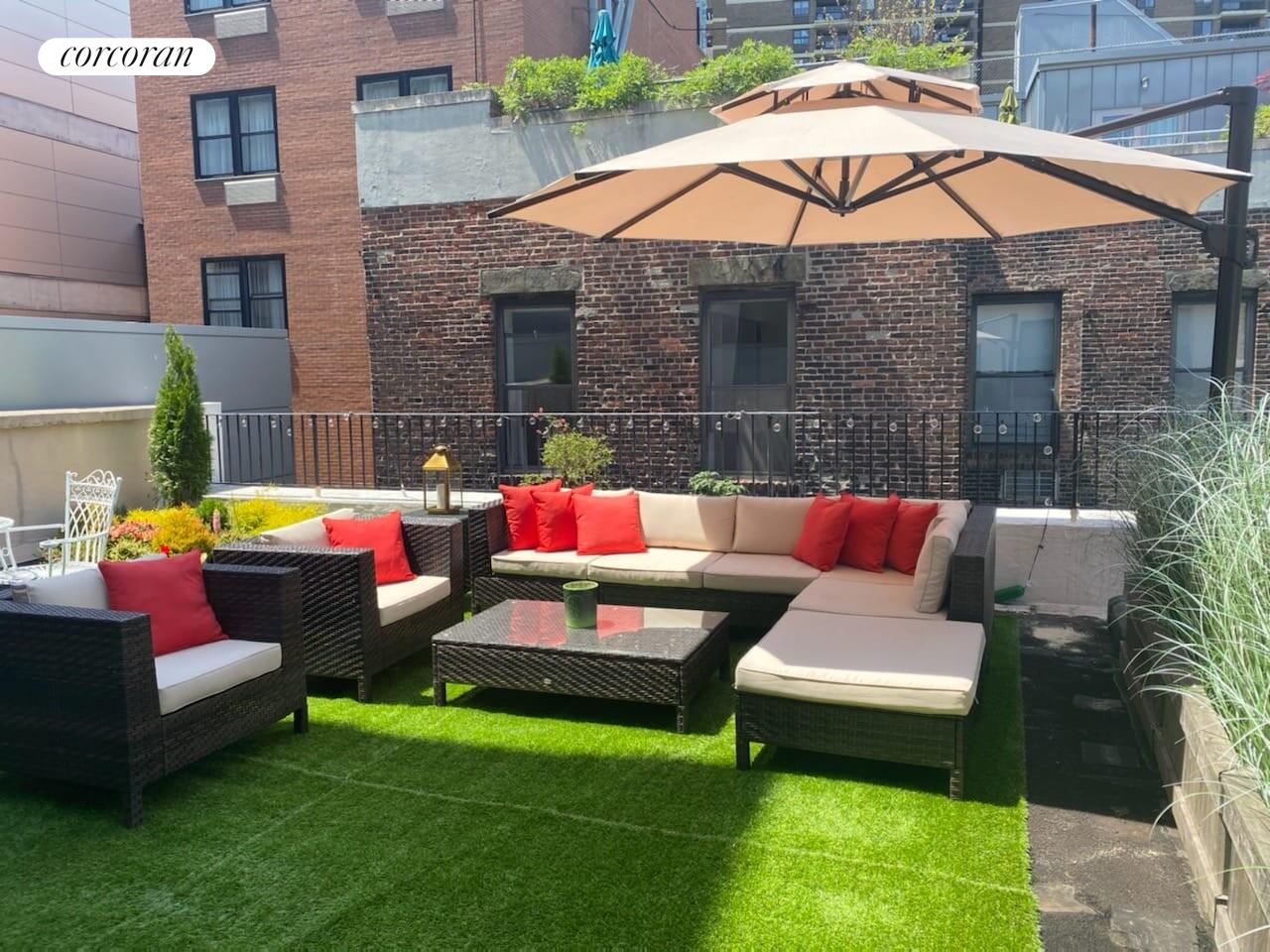 264 Water Street, Unit PHD Manhattan, NY 10038 - Photo 3 of 13 a white house with a yard table and chairs