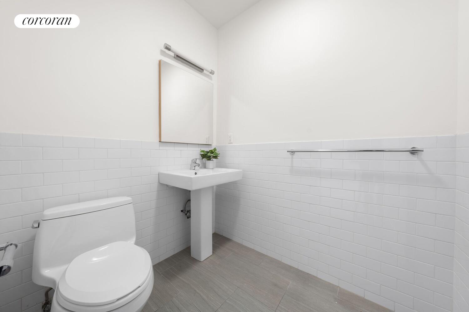 264 Water Street, Unit PHD Manhattan, NY 10038 - Photo 5 of 13 a bathroom with a sink toilet and mirror