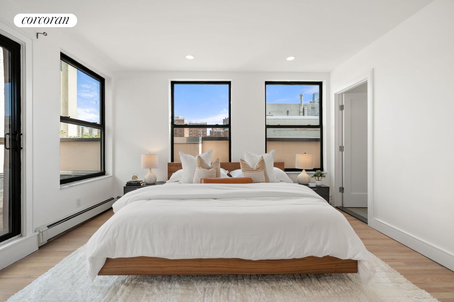 264 Water Street, Unit PHD Manhattan, NY 10038 - Photo 6 of 13 a bedroom with a bed and glass windows