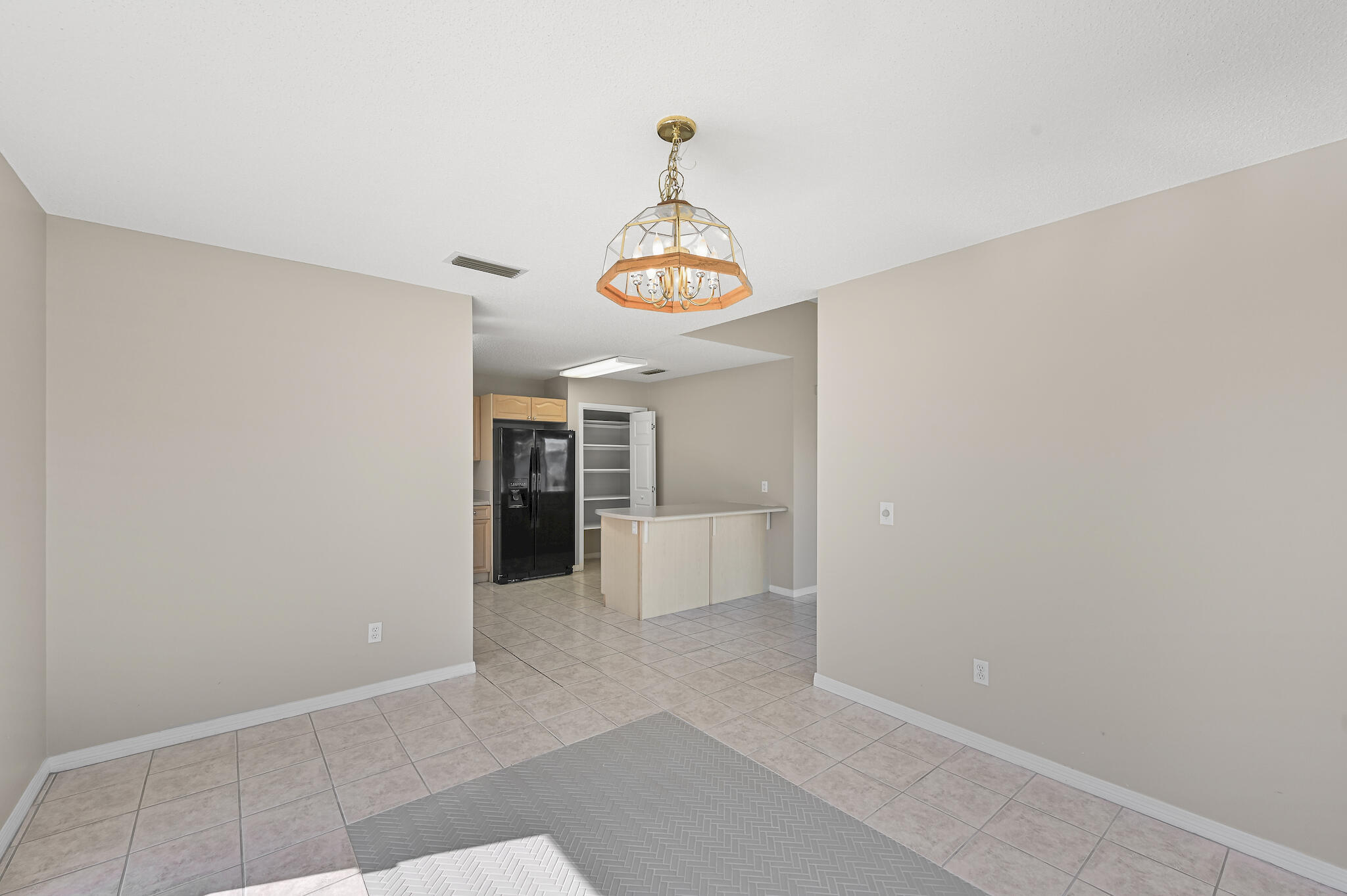 292 West Harborview Road Santa Rosa Beach, FL 32459 - Photo 11 of 43 a hallway with sliding door and chandelier
