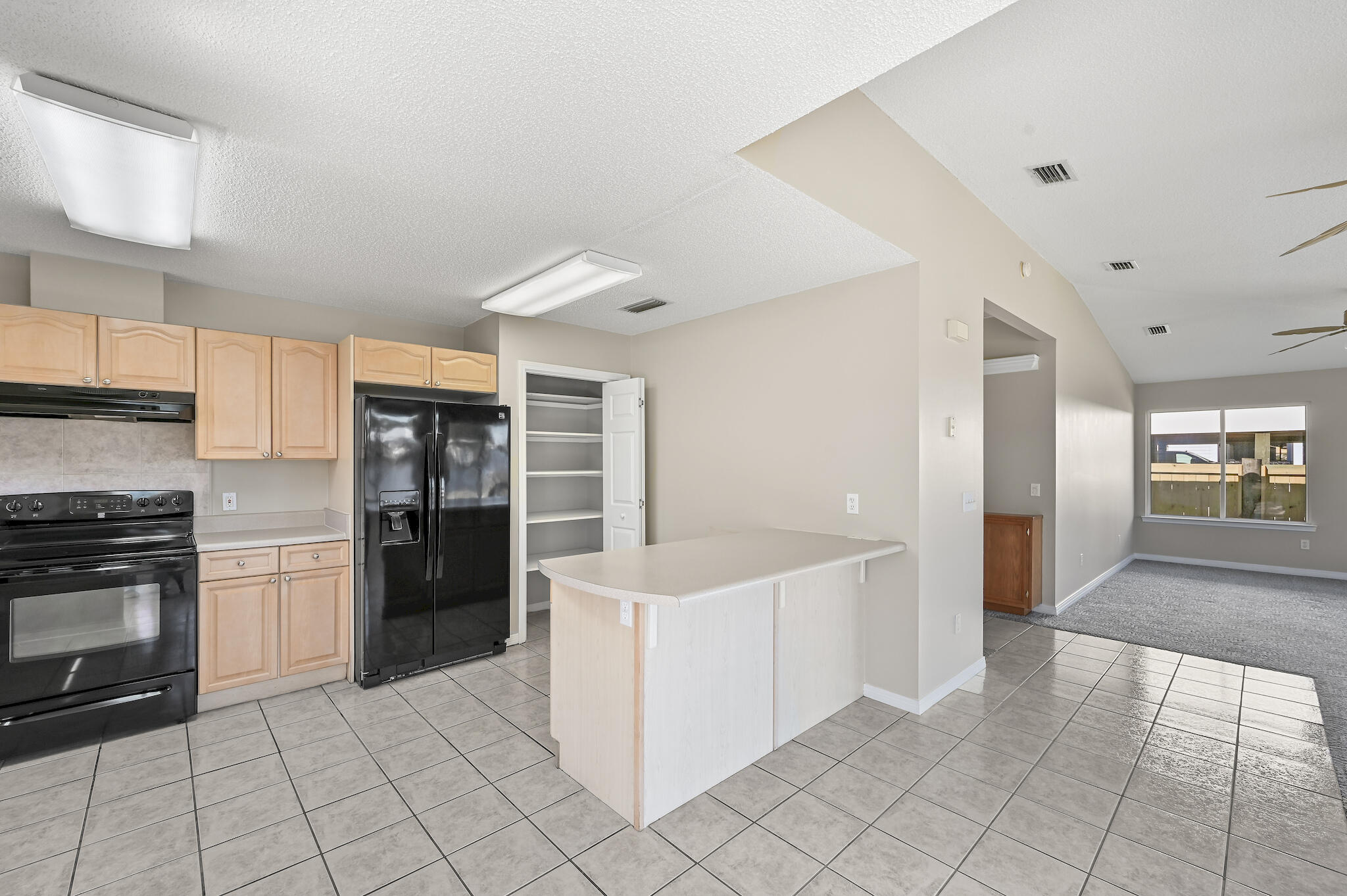 292 West Harborview Road Santa Rosa Beach, FL 32459 - Photo 12 of 43 a kitchen with granite countertop a refrigerator and a stove top oven