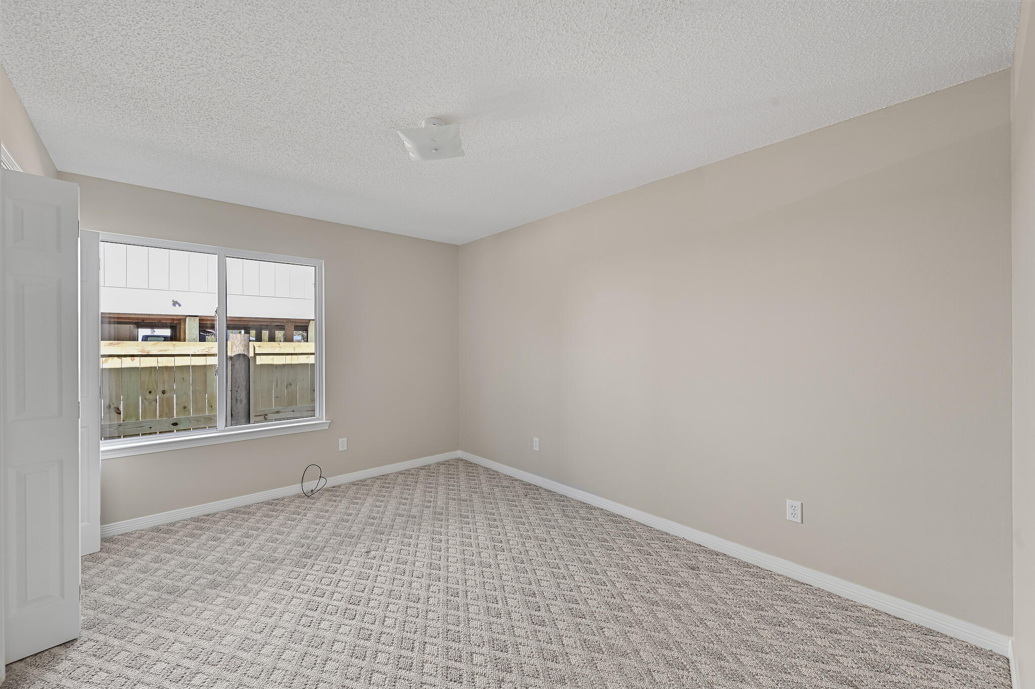 292 West Harborview Road Santa Rosa Beach, FL 32459 - Photo 14 of 43 wooden floor in an empty room with a window