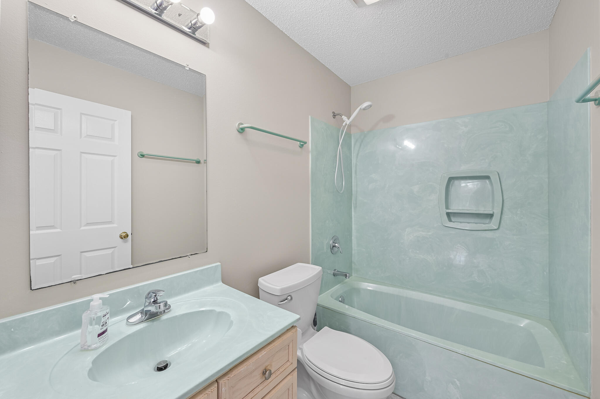 292 West Harborview Road Santa Rosa Beach, FL 32459 - Photo 15 of 43 a bathroom with a bathtub shower sink vanity mirror and toilet
