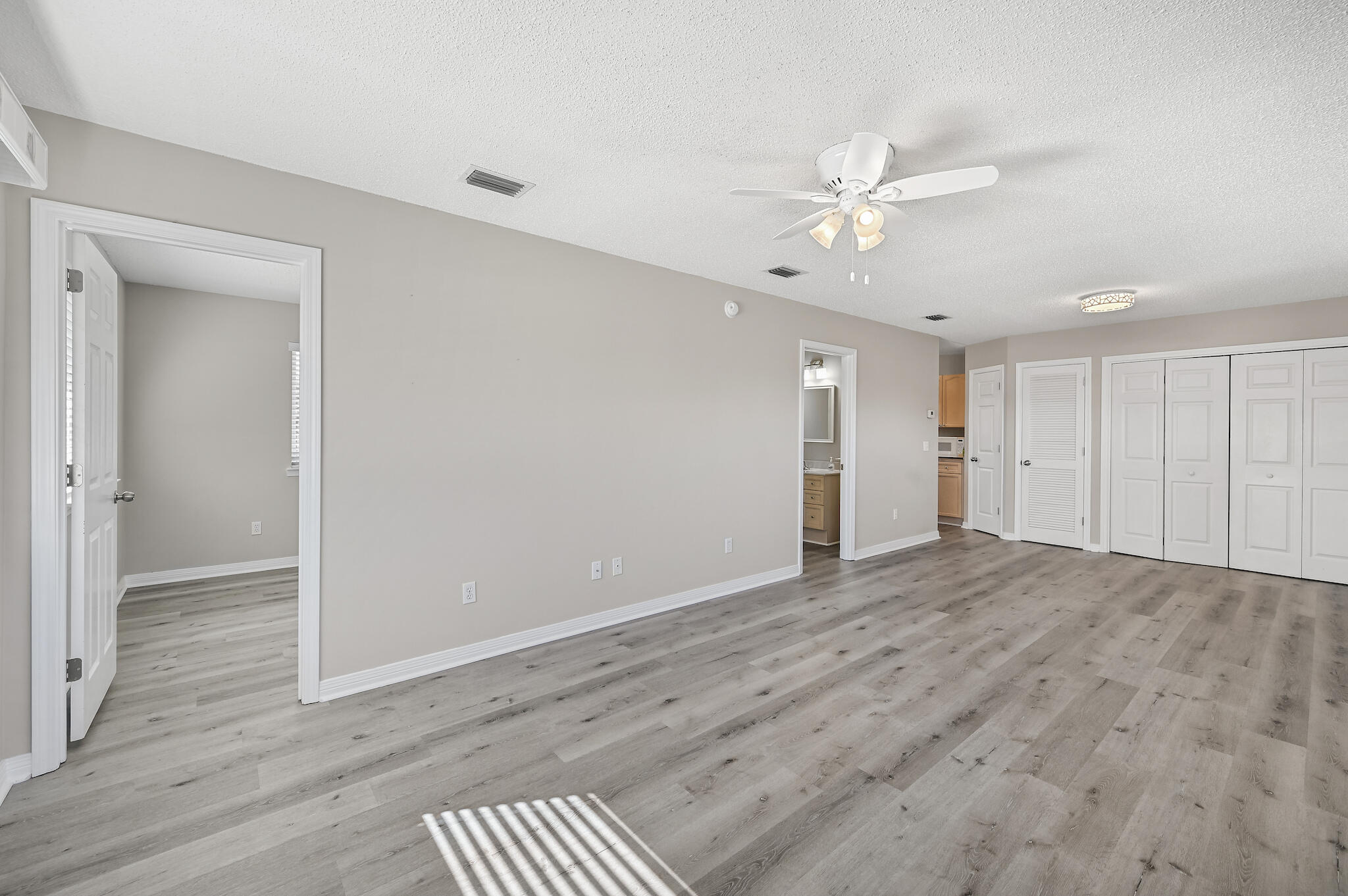 292 West Harborview Road Santa Rosa Beach, FL 32459 - Photo 25 of 43 a view of an empty room with wooden floor
