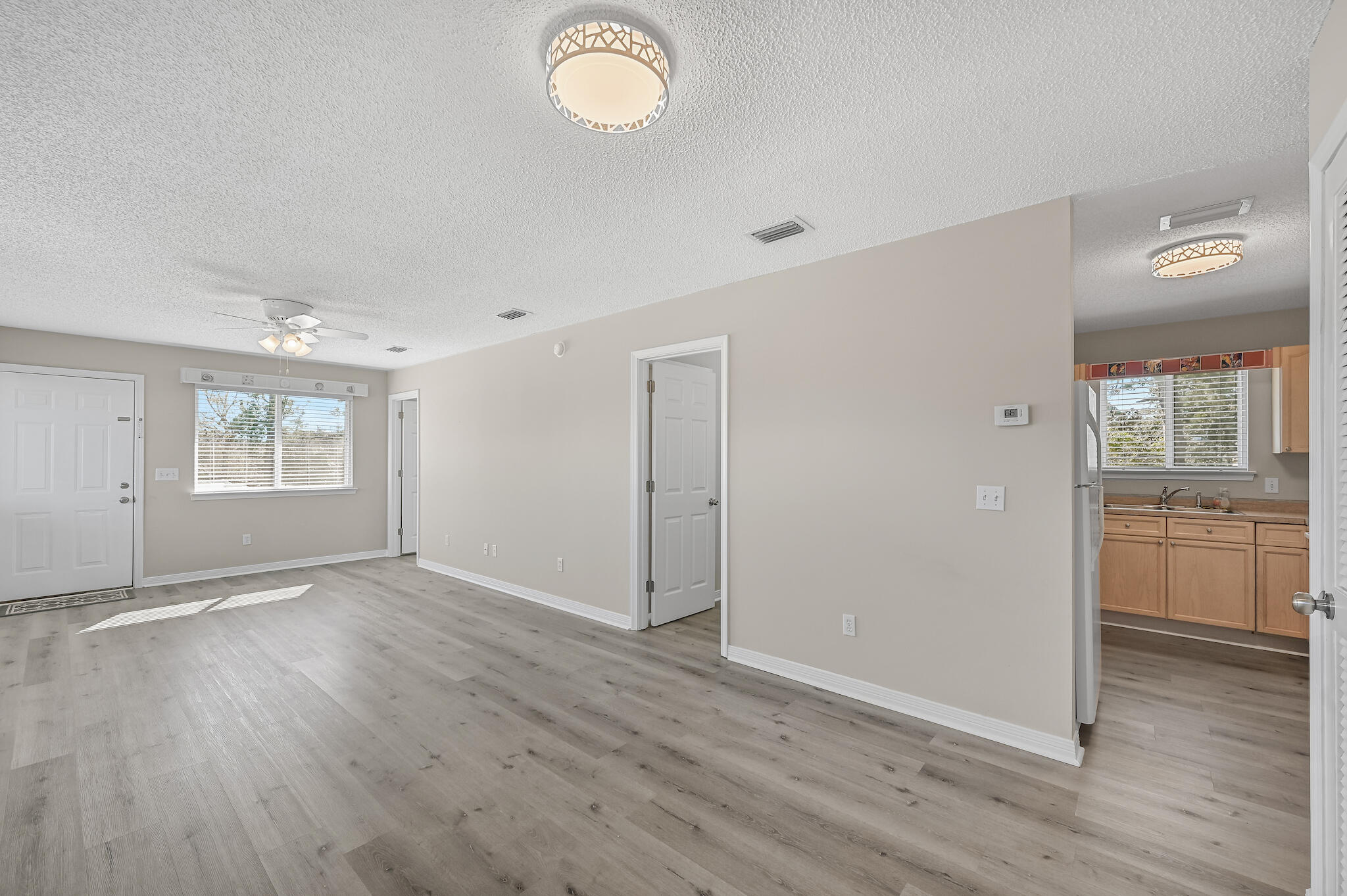 292 West Harborview Road Santa Rosa Beach, FL 32459 - Photo 26 of 43 an empty room with wooden floor and windows