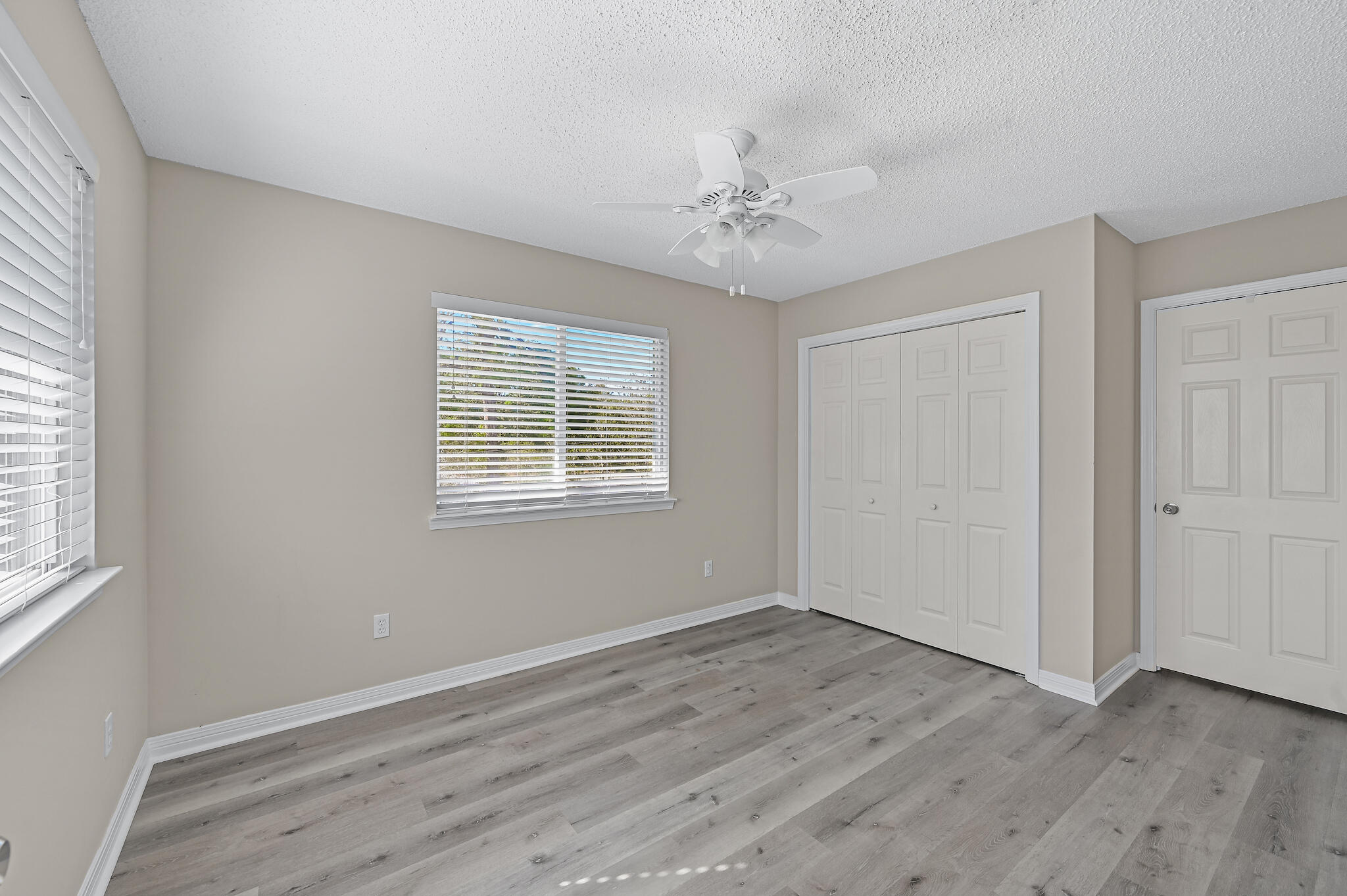 292 West Harborview Road Santa Rosa Beach, FL 32459 - Photo 30 of 43 a view of an empty room with wooden floor and a window