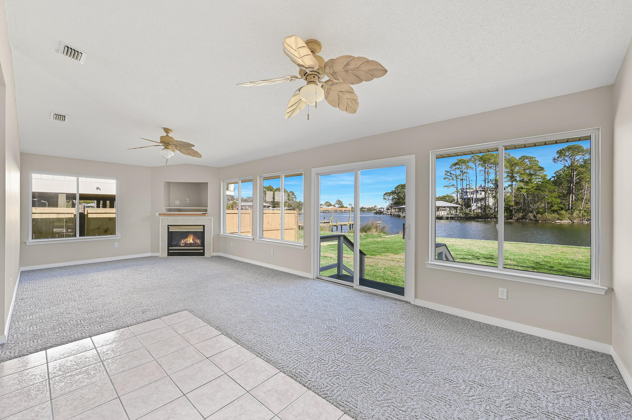 292 West Harborview Road Santa Rosa Beach, FL 32459 - Photo 3 of 43 a view of a livingroom with furniture a fireplace a ceiling fan and window
