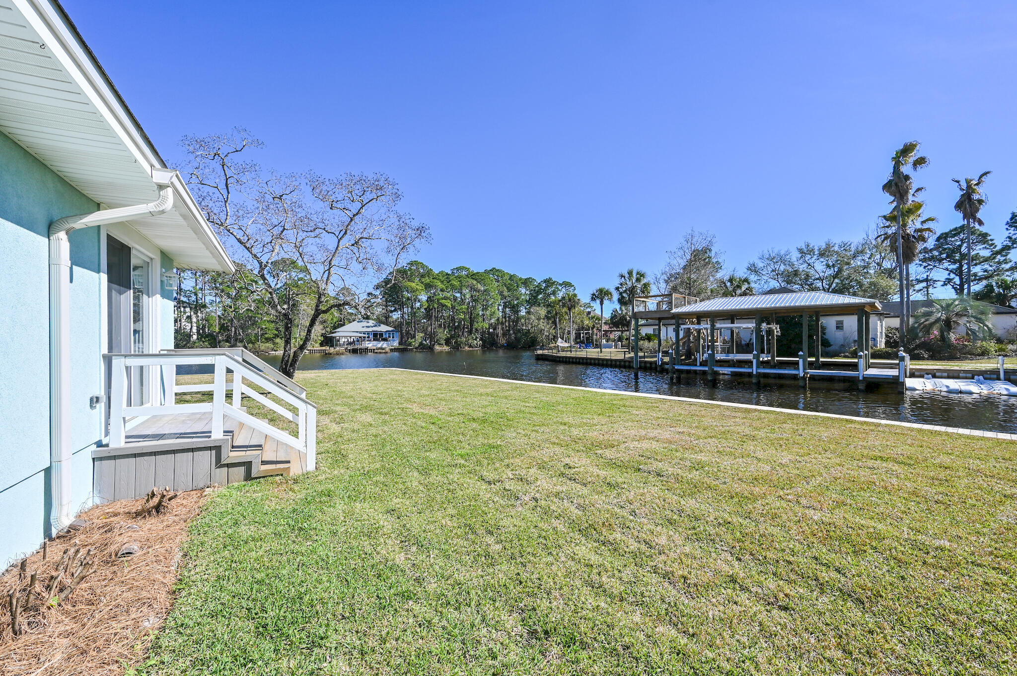 292 West Harborview Road Santa Rosa Beach, FL 32459 - Photo 41 of 43 a view of a house with pool and a yard