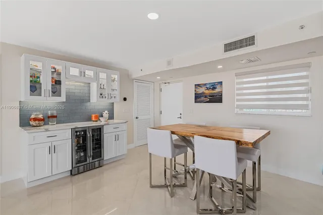 a kitchen that has a table and chairs in it
