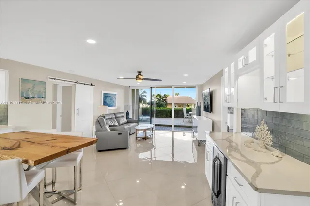 a spacious bathroom with a granite countertop sink a large mirror and shower