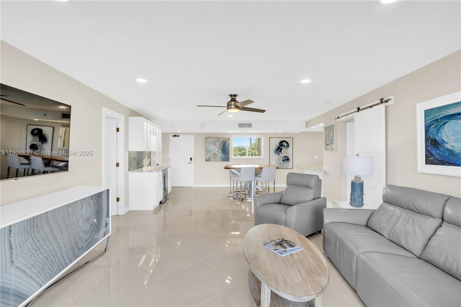 300 Ocean Trail Way, Unit 108 Jupiter, FL 33477 - Photo 6 of 21 a living room with furniture and a large window