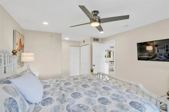 a bedroom with a bed and a television