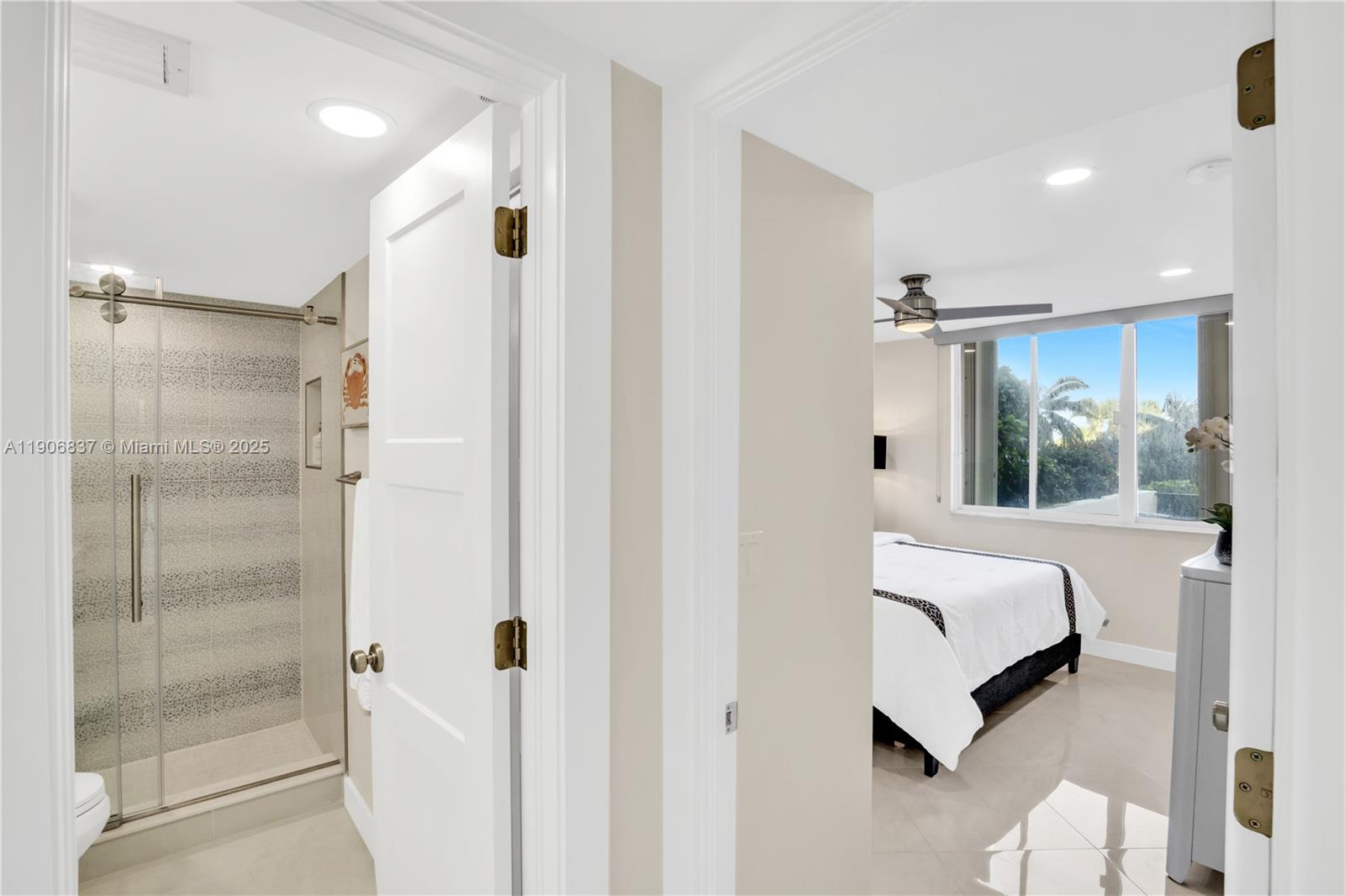 300 Ocean Trail Way, Unit 108 Jupiter, FL 33477 - Photo 9 of 21 a bedroom with a bed and a mirror