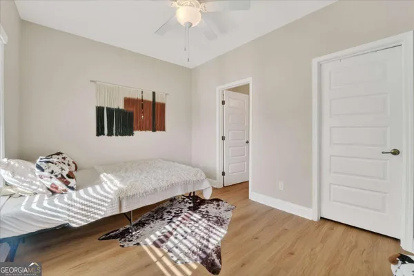 a bedroom with a bed and a chandelier