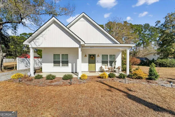 a front view of a house with garden