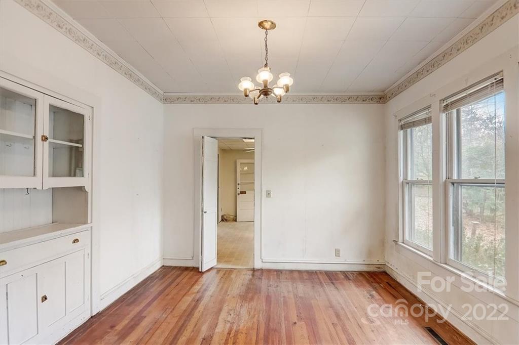 121 Edwards Road Clyde, NC 28721 - Photo 14 of 48 a view of an empty room with a window and wooden floor