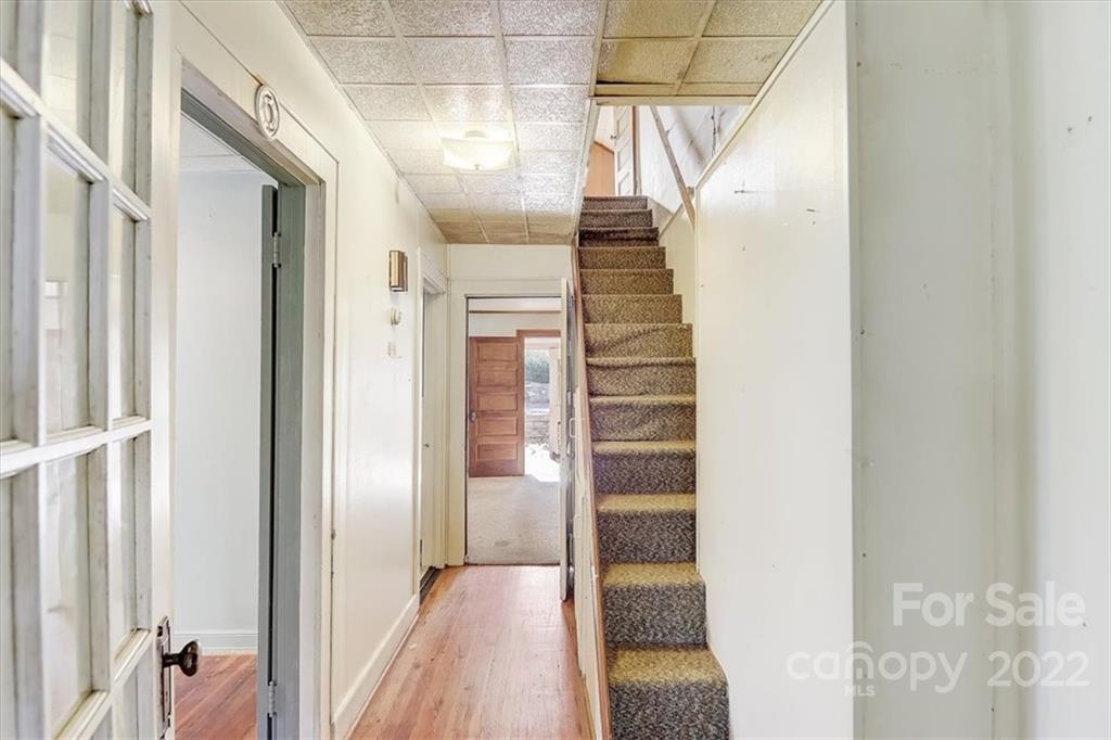121 Edwards Road Clyde, NC 28721 - Photo 27 of 48 a view of a hallway with wooden floor and staircase