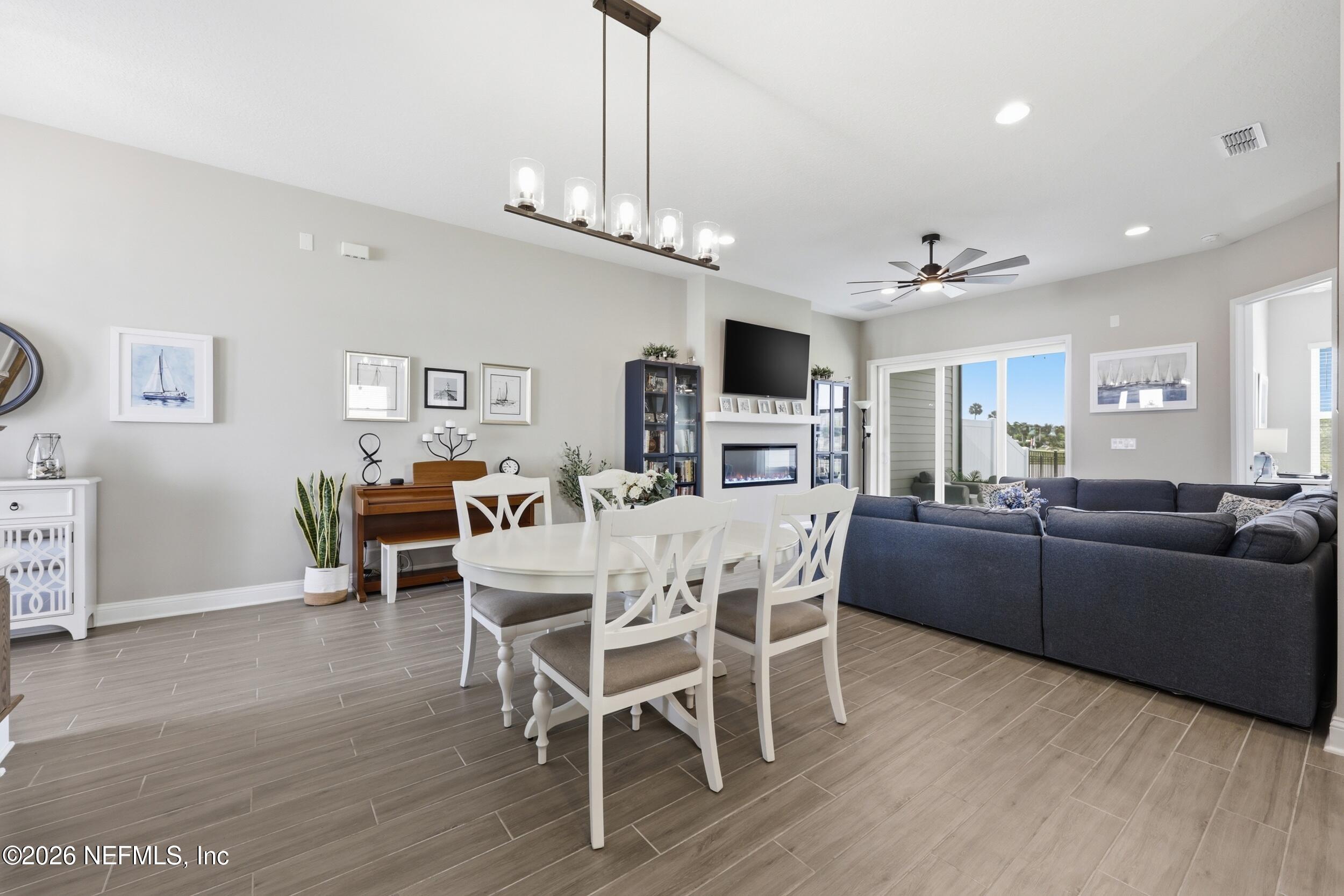 439 Rum Runner Way St. Johns, FL 32259 - Photo 11 of 82 a living room with furniture a dining table and a flat screen tv