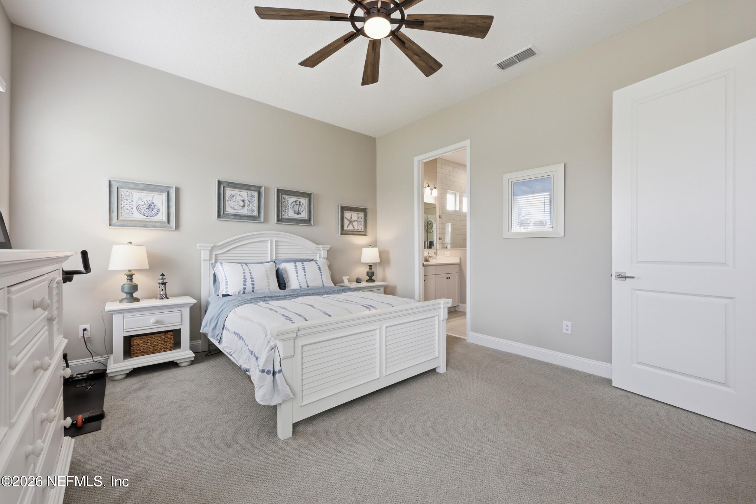 439 Rum Runner Way St. Johns, FL 32259 - Photo 22 of 82 a bed room with a bed and a chandelier