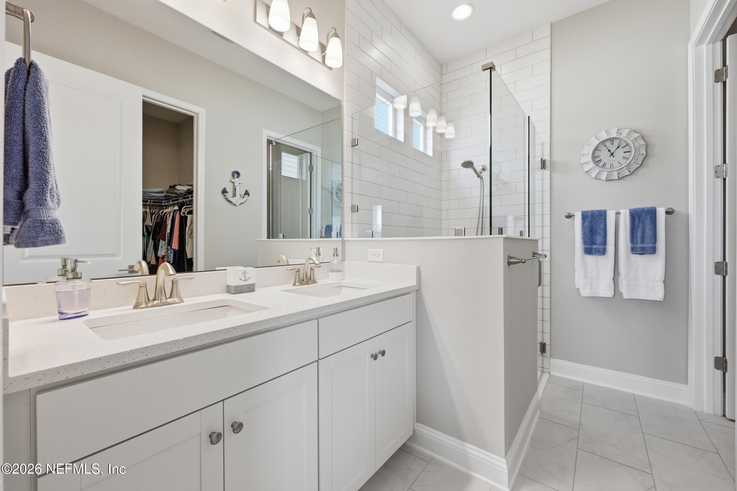 439 Rum Runner Way St. Johns, FL 32259 - Photo 25 of 82 a bathroom with a double vanity sink mirror and shower