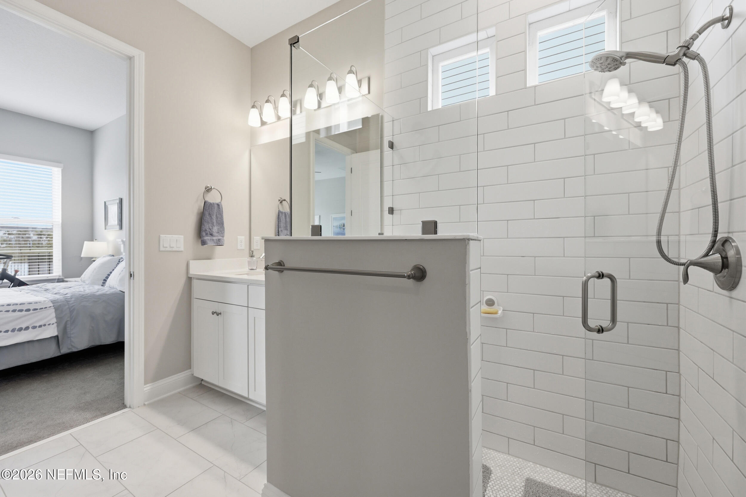 439 Rum Runner Way St. Johns, FL 32259 - Photo 26 of 82 a bathroom with a double vanity sink a mirror and a shower