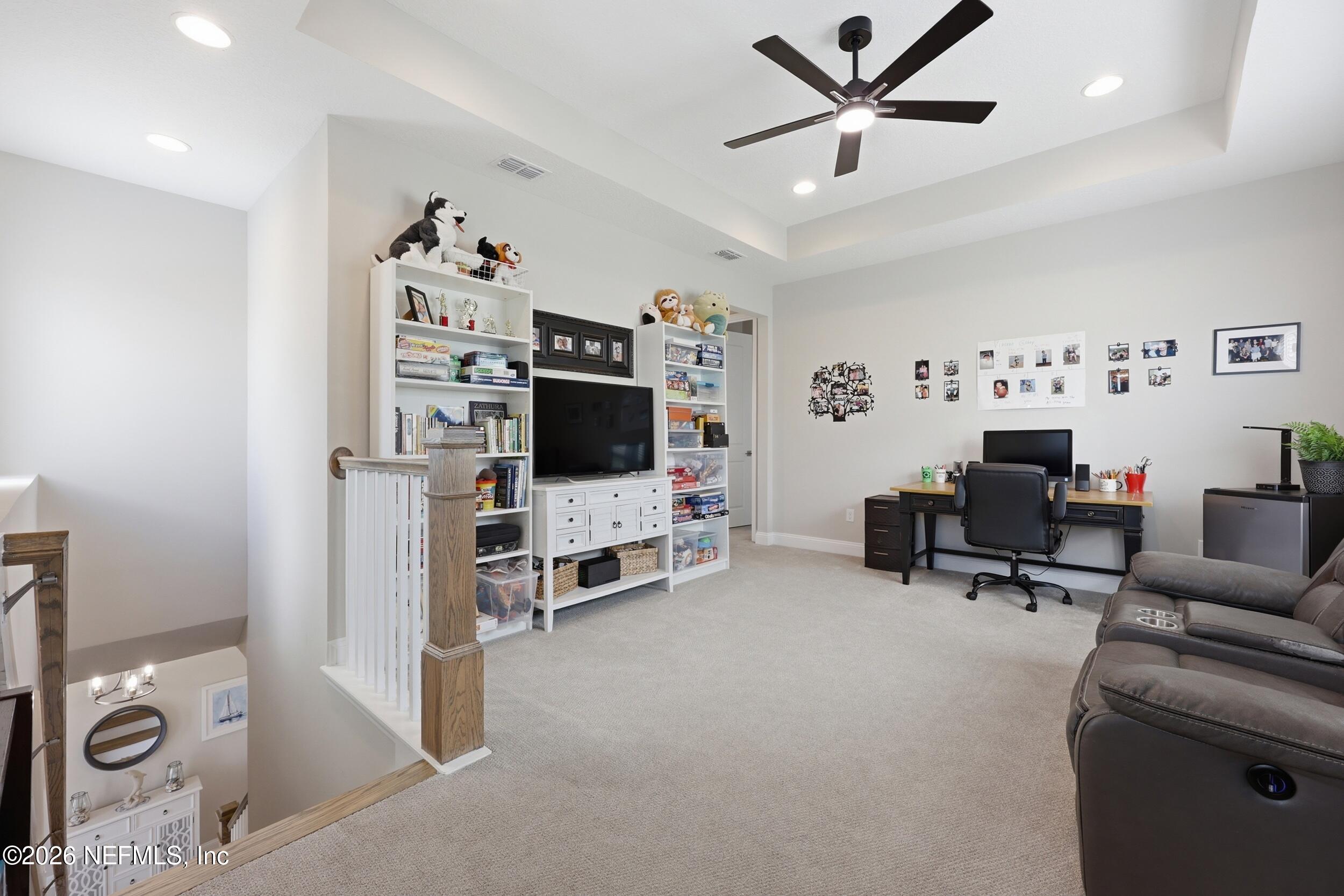 439 Rum Runner Way St. Johns, FL 32259 - Photo 30 of 82 a living room with furniture and a flat screen tv