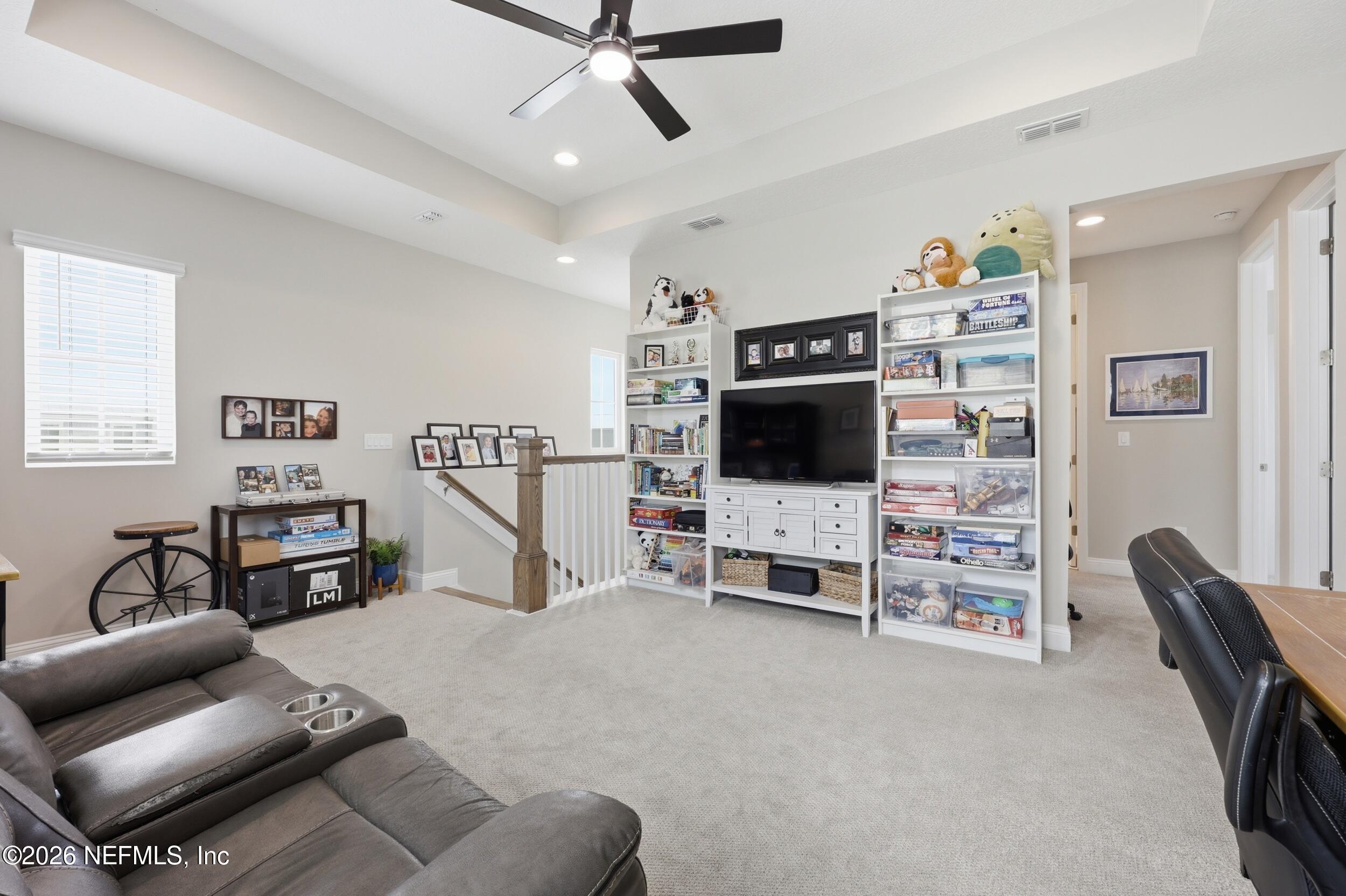 439 Rum Runner Way St. Johns, FL 32259 - Photo 33 of 82 a living room with furniture and a flat screen tv