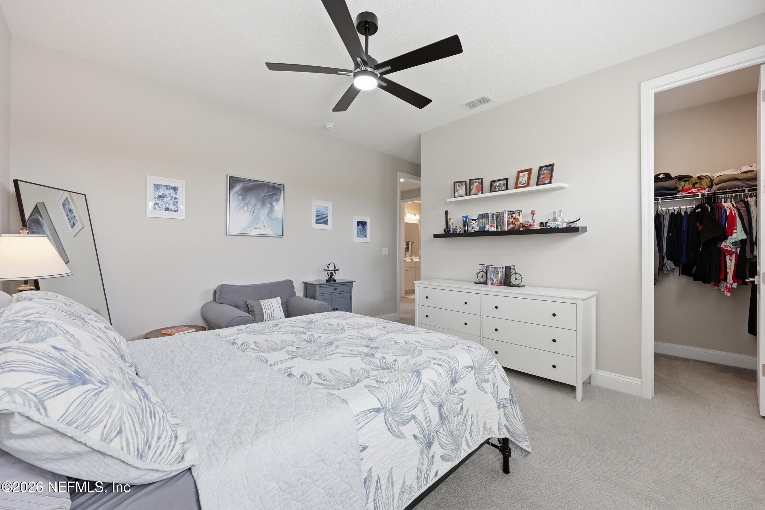 439 Rum Runner Way St. Johns, FL 32259 - Photo 36 of 82 a bedroom with a bed and a cabinets