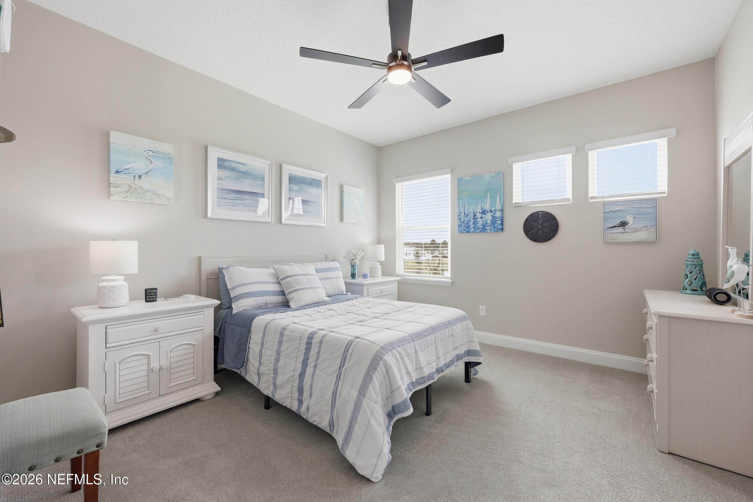 439 Rum Runner Way St. Johns, FL 32259 - Photo 38 of 82 a spacious bedroom with a bed and a table